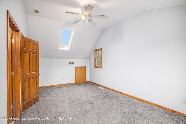 3037 Hawley Rd, Leslie, MI 49251 - additional living space with vaulted ceiling, carpet, a skylight, baseboards, and ceiling fan
