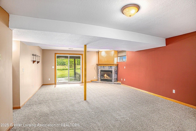 3037 Hawley Rd, Leslie, MI 49251 - unfurnished living room with carpet floors, a textured ceiling, a glass covered fireplace, and baseboards