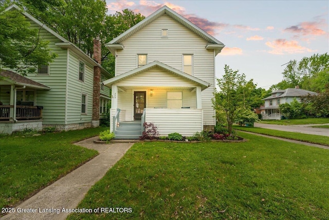 329 Smith Ave, Lansing, MI 48910 - view of front facade with a porch and a lawn