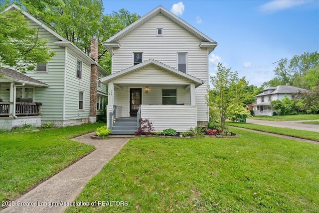 329 Smith Ave, Lansing, MI 48910 - traditional style home with a porch and a front lawn