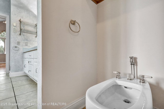4250 S Williams Rd, Stockbridge, MI 49285 - bathroom with tile patterned flooring, a towel warmer, and baseboards