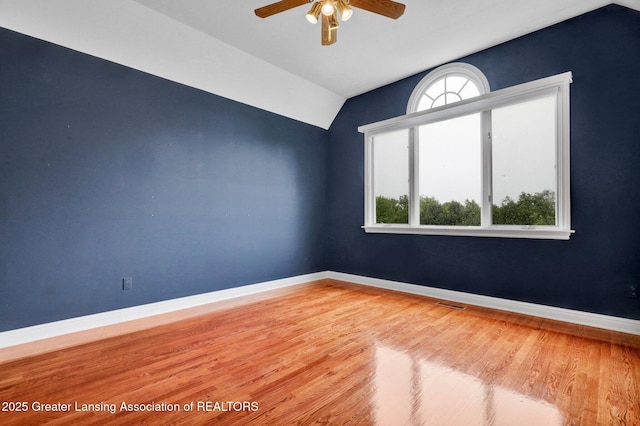 4250 S Williams Rd, Stockbridge, MI 49285 - unfurnished room with lofted ceiling, ceiling fan, wood finished floors, and baseboards