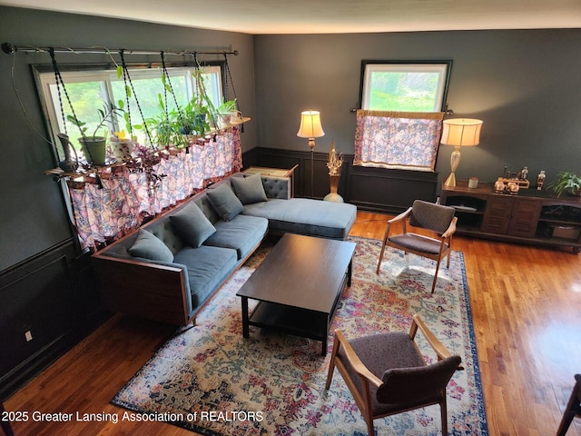 710 Gainsborough Dr, East Lansing, MI 48823 - living room featuring a wainscoted wall and wood finished floors