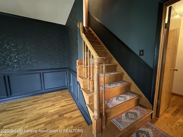 710 Gainsborough Dr, East Lansing, MI 48823 - stairs featuring wood finished floors, a wainscoted wall, wallpapered walls, and a decorative wall