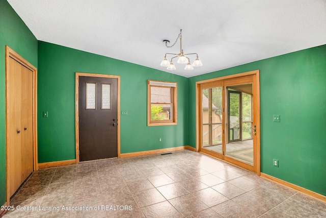 710 Gainsborough Dr, East Lansing, MI 48823 - tiled entrance foyer with a chandelier, baseboards, and lofted ceiling
