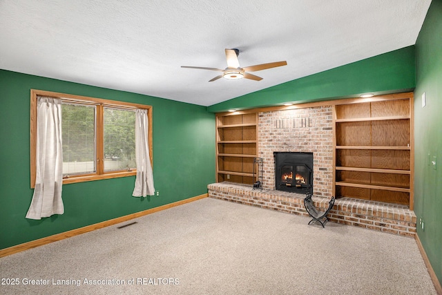 710 Gainsborough Dr, East Lansing, MI 48823 - unfurnished living room with ceiling fan, baseboards, carpet floors, vaulted ceiling, and a textured ceiling