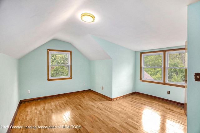 710 Gainsborough Dr, East Lansing, MI 48823 - additional living space featuring wood finished floors, lofted ceiling, and baseboards