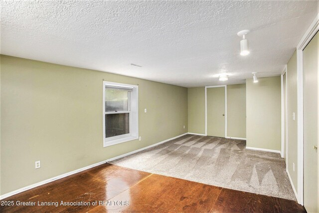 710 Gainsborough Dr, East Lansing, MI 48823 - finished below grade area featuring a textured ceiling and baseboards