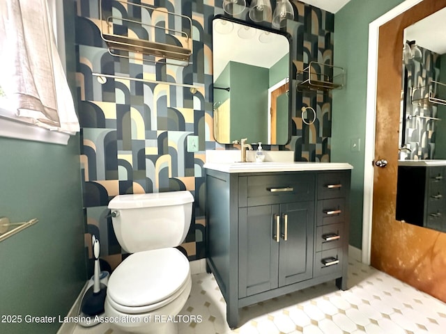 710 Gainsborough Dr, East Lansing, MI 48823 - bathroom featuring vanity, toilet, and baseboards