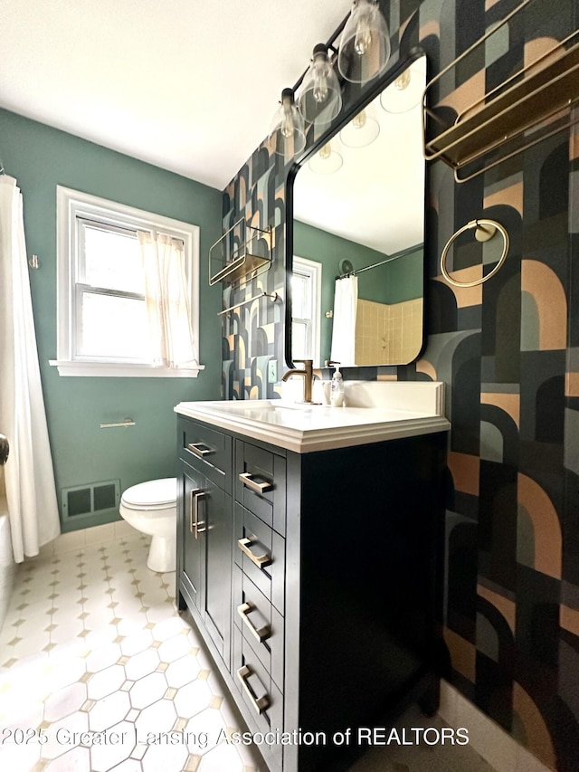 710 Gainsborough Dr, East Lansing, MI 48823 - full bathroom with vanity, toilet, and tile patterned floors
