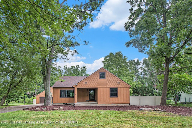 710 Gainsborough Dr, East Lansing, MI 48823 - view of front facade featuring a garage, a shingled roof, driveway, and a porch
