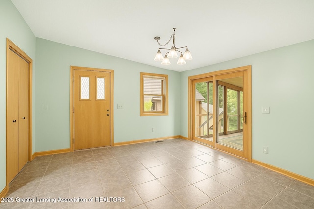 710 Gainsborough Dr, East Lansing, MI 48823 - entrance foyer with a chandelier and light tile patterned floors