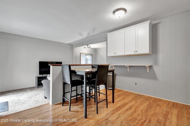 1580 Grayfriars Ave, Holt, MI 48842 - dining space with light wood-type flooring and a decorative wall