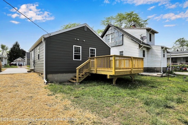 209 Haze St, Lansing, MI 48917 - back of property with a deck and a yard