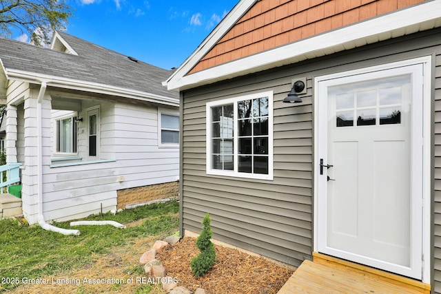 209 Haze St, Lansing, MI 48917 - view of exterior entry featuring roof with shingles