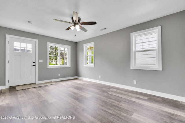 209 Haze St, Lansing, MI 48917 - entryway with a ceiling fan, wood finished floors, and baseboards