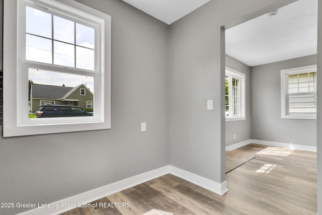 209 Haze St, Lansing, MI 48917 - empty room featuring wood finished floors, baseboards, and a smoke detector