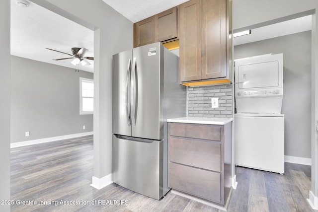 209 Haze St, Lansing, MI 48917 - kitchen featuring freestanding refrigerator, stacked washer / drying machine, ceiling fan, and baseboards