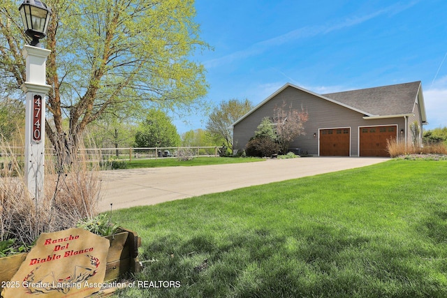 4740 Round Lake Rd, Laingsburg, MI 48848 - view of side of home with a yard and concrete driveway