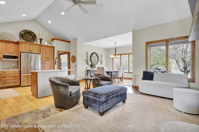 4740 Round Lake Rd, Laingsburg, MI 48848 - living area featuring light wood finished floors, a ceiling fan, recessed lighting, high vaulted ceiling, and a chandelier
