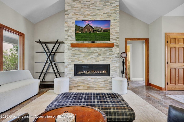 4740 Round Lake Rd, Laingsburg, MI 48848 - living room with lofted ceiling, wood finished floors, a stone fireplace, and baseboards