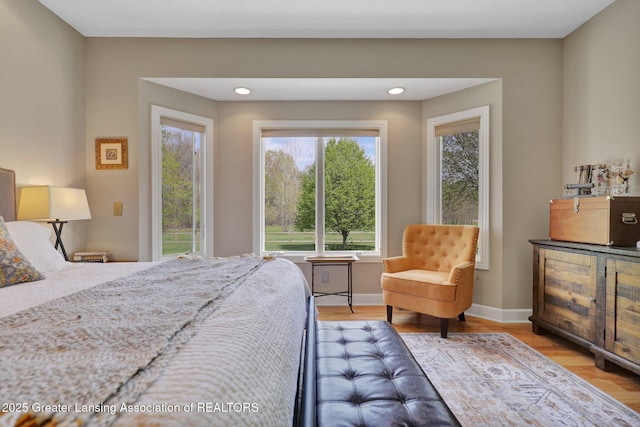 4740 Round Lake Rd, Laingsburg, MI 48848 - bedroom with multiple windows, access to outside, light wood-style floors, baseboards, and recessed lighting