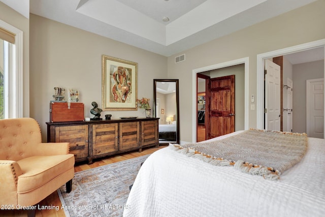 4740 Round Lake Rd, Laingsburg, MI 48848 - bedroom featuring light wood-type flooring and a raised ceiling
