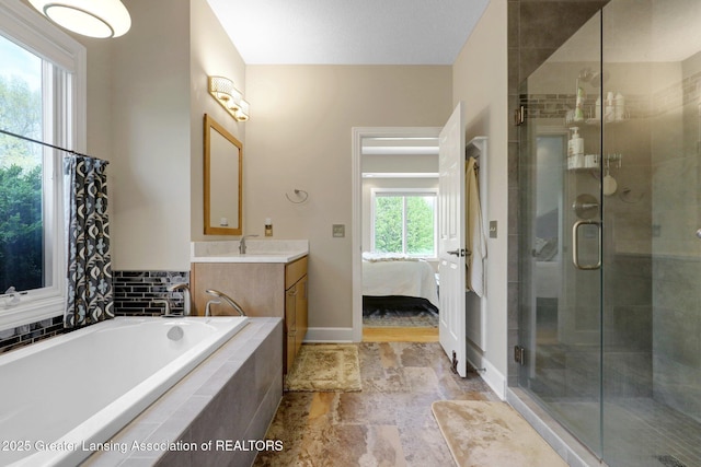 4740 Round Lake Rd, Laingsburg, MI 48848 - full bath with vanity, a stall shower, a garden tub, ensuite bath, and baseboards