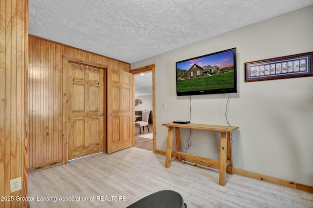 4740 Round Lake Rd, Laingsburg, MI 48848 - foyer with wood finished floors, baseboards, wood walls, and a textured ceiling