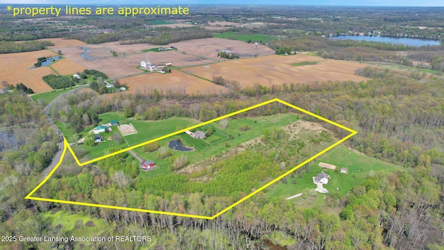 4740 Round Lake Rd, Laingsburg, MI 48848 - view of rural area featuring property parcel outlined, a nearby body of water, and a heavily wooded area