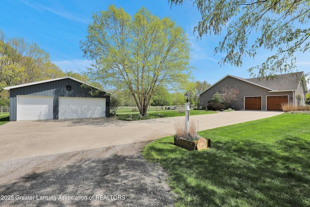 4740 Round Lake Rd, Laingsburg, MI 48848 - view of side of property with a lawn, an outdoor structure, and a garage