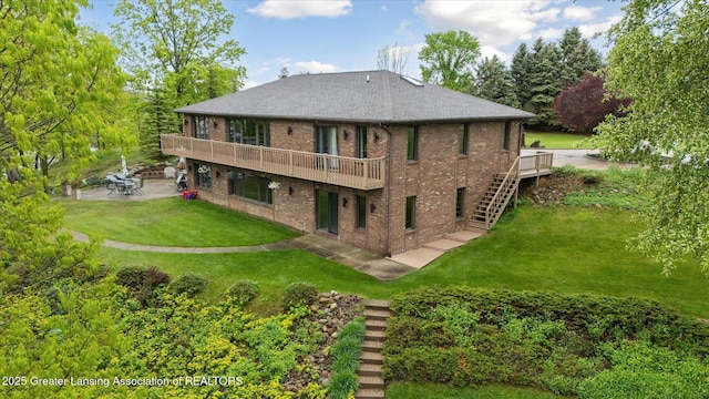 10949 Lakeside Dr, Perrinton, MI 48871 - back of property with stairs, a patio, brick siding, a deck, and a yard