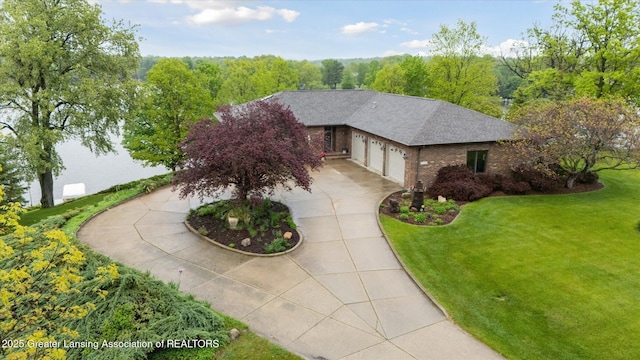 10949 Lakeside Dr, Perrinton, MI 48871 - view of front facade featuring brick siding, concrete driveway, a front yard, a garage, and a shingled roof