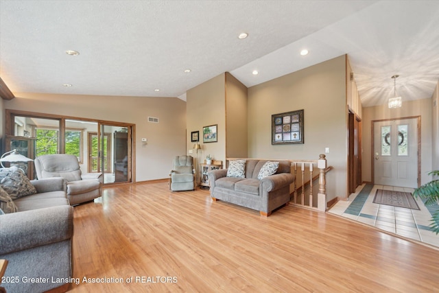 10949 Lakeside Dr, Perrinton, MI 48871 - living room with light wood-style flooring, baseboards, recessed lighting, a chandelier, and high vaulted ceiling