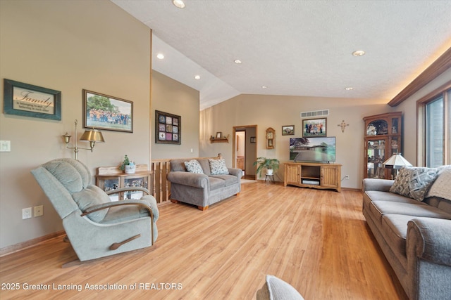 10949 Lakeside Dr, Perrinton, MI 48871 - living area featuring light wood-style floors, recessed lighting, vaulted ceiling, and baseboards