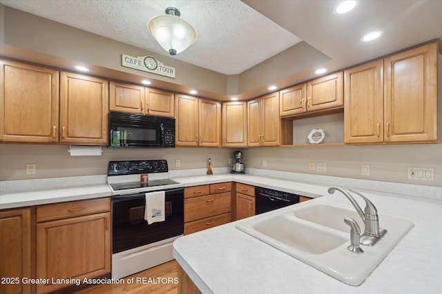 10949 Lakeside Dr, Perrinton, MI 48871 - kitchen featuring black appliances, a sink, a textured ceiling, light countertops, and recessed lighting