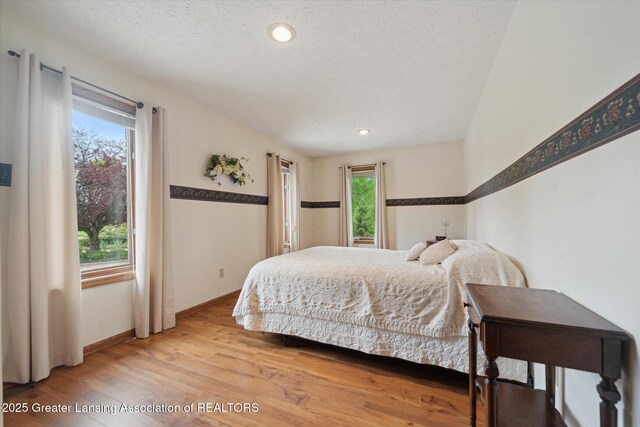 10949 Lakeside Dr, Perrinton, MI 48871 - bedroom featuring light wood-type flooring, baseboards, and recessed lighting
