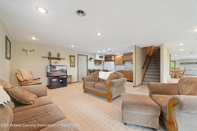 10949 Lakeside Dr, Perrinton, MI 48871 - living area with stairs, recessed lighting, light carpet, and baseboards