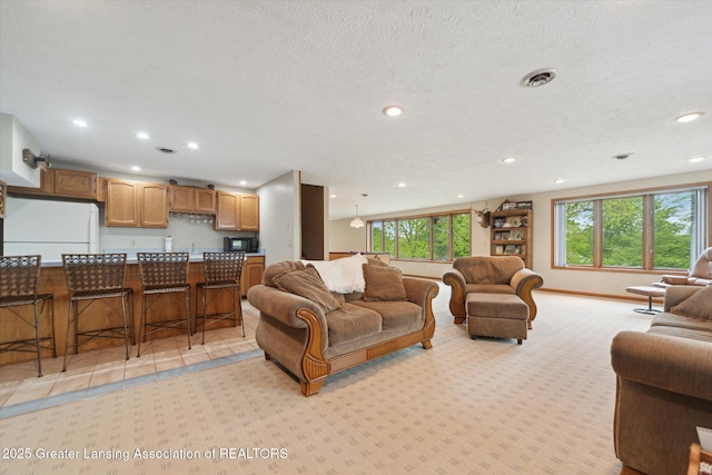10949 Lakeside Dr, Perrinton, MI 48871 - living room featuring healthy amount of natural light, recessed lighting, light colored carpet, and baseboards