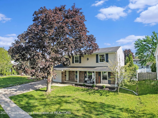 3229 Inverary Dr, Lansing, MI 48911 - traditional-style home with concrete driveway, a porch, brick siding, and roof with shingles
