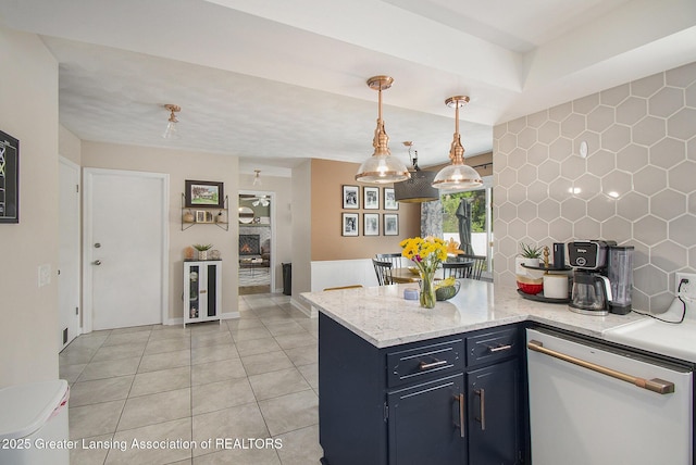 3229 Inverary Dr, Lansing, MI 48911 - kitchen with white dishwasher, a peninsula, decorative light fixtures, light tile patterned floors, and light stone counters