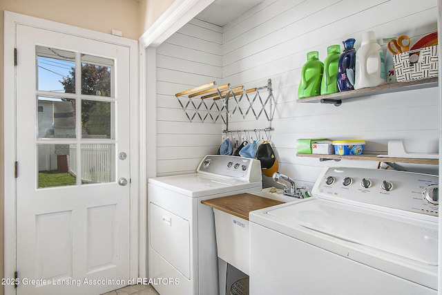 3229 Inverary Dr, Lansing, MI 48911 - laundry area with washer and clothes dryer and wood walls