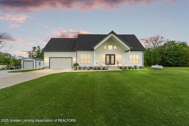 8924 Chicory Ln, Portland, MI 48875 - view of front of home featuring french doors, a lawn, driveway, an attached garage, and roof with shingles