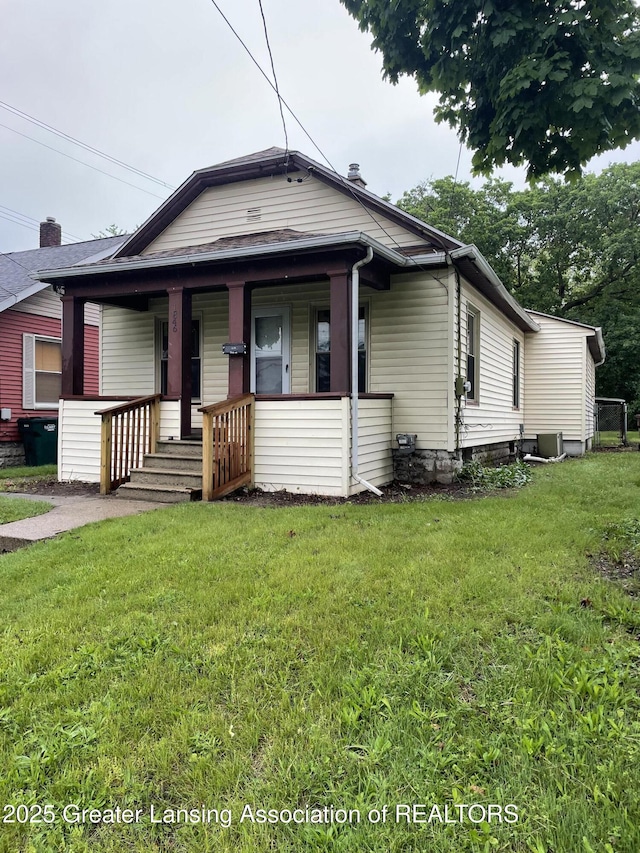 1846 Davis Ave, Lansing, MI 48910 - view of front of property with a porch, a front yard, and central AC unit