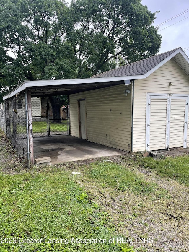 1846 Davis Ave, Lansing, MI 48910 - garage featuring an attached carport