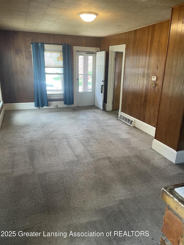 1846 Davis Ave, Lansing, MI 48910 - spare room featuring wooden walls and carpet