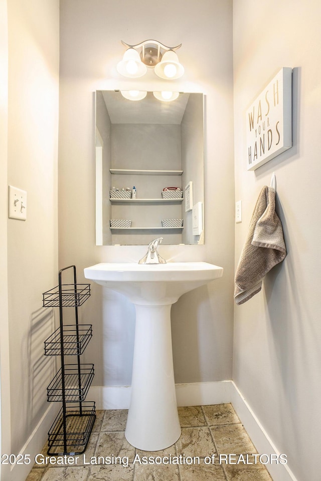 15145 Nottingham Fields Pkwy, Lansing, MI 48906 - bathroom featuring baseboards and a sink