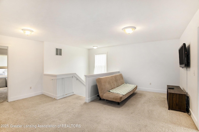 15145 Nottingham Fields Pkwy, Lansing, MI 48906 - living area featuring carpet floors, an upstairs landing, and baseboards
