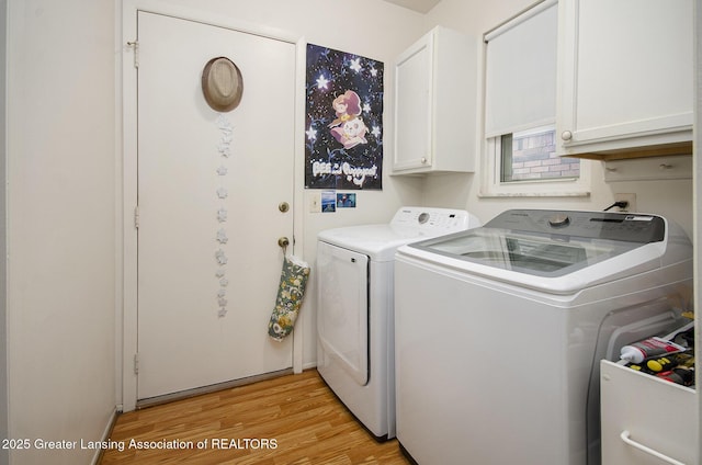 37936 Watkins Dr Unit 32, Sterling Heights, MI 48312 - laundry area featuring washing machine and dryer, light wood finished floors, and cabinet space