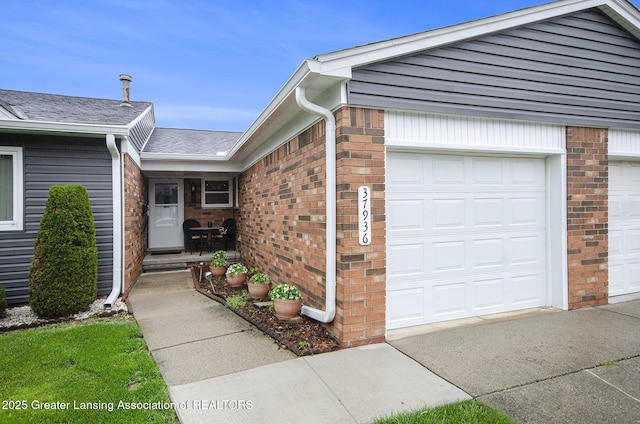 37936 Watkins Dr Unit 32, Sterling Heights, MI 48312 - property entrance featuring brick siding, a shingled roof, and an attached garage